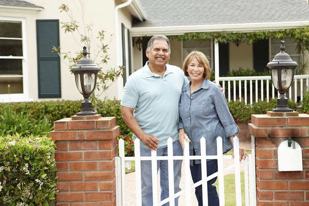 Happy family in front of their home